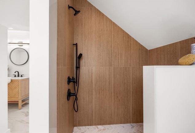 A cozy bathroom retreat utilizing Ribbon Oak matte ceramic tiles to achieve a warm wood look.